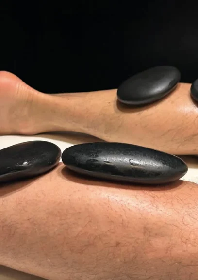 Detalle de una sesión de masaje con piedras calientes